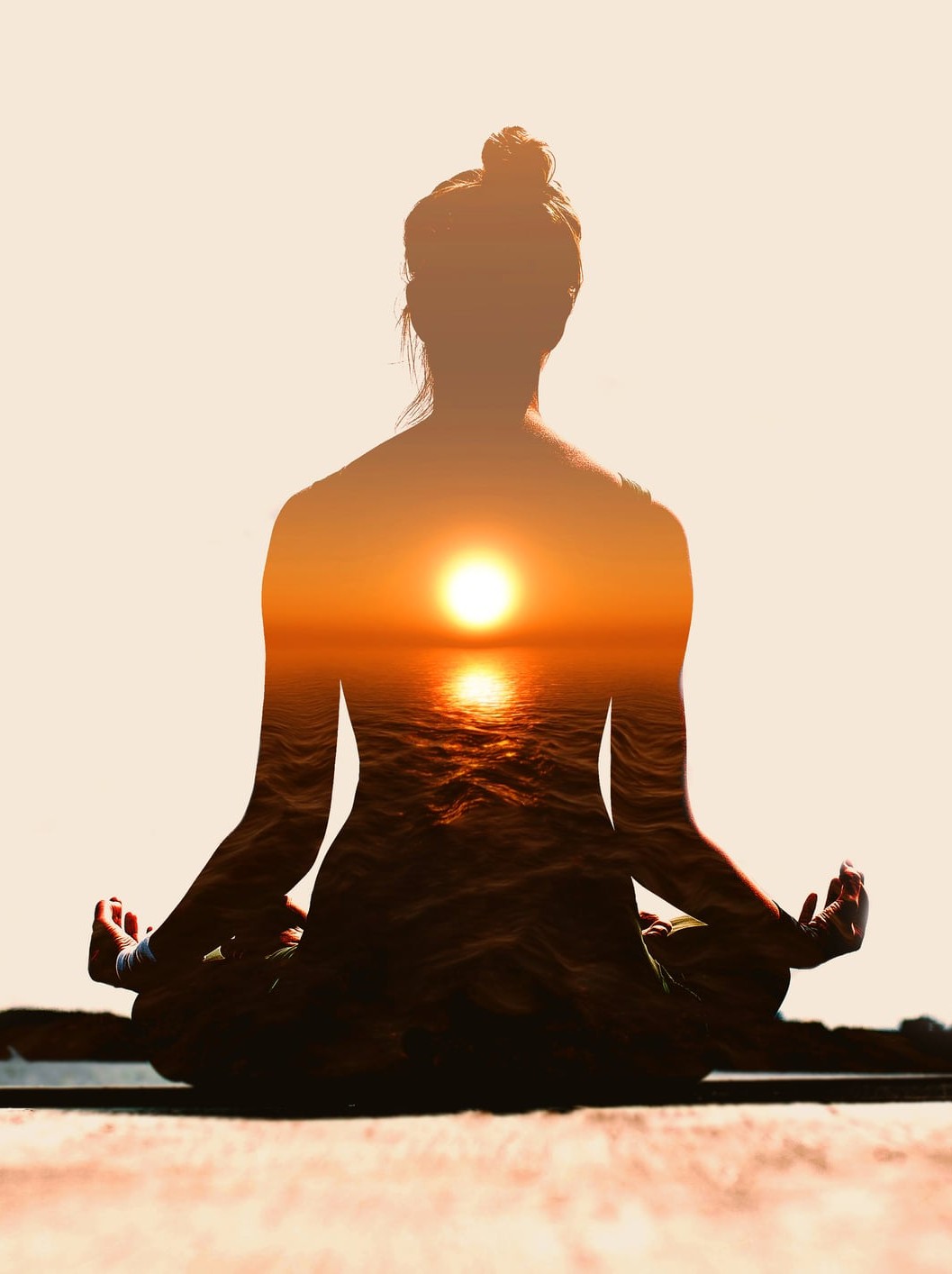 Woman practicing yoga at sunset