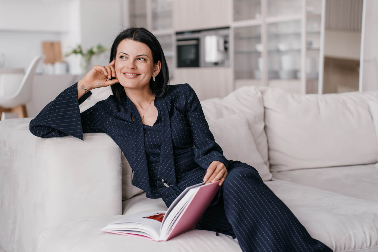 Woman sitting on the couch looking over the window