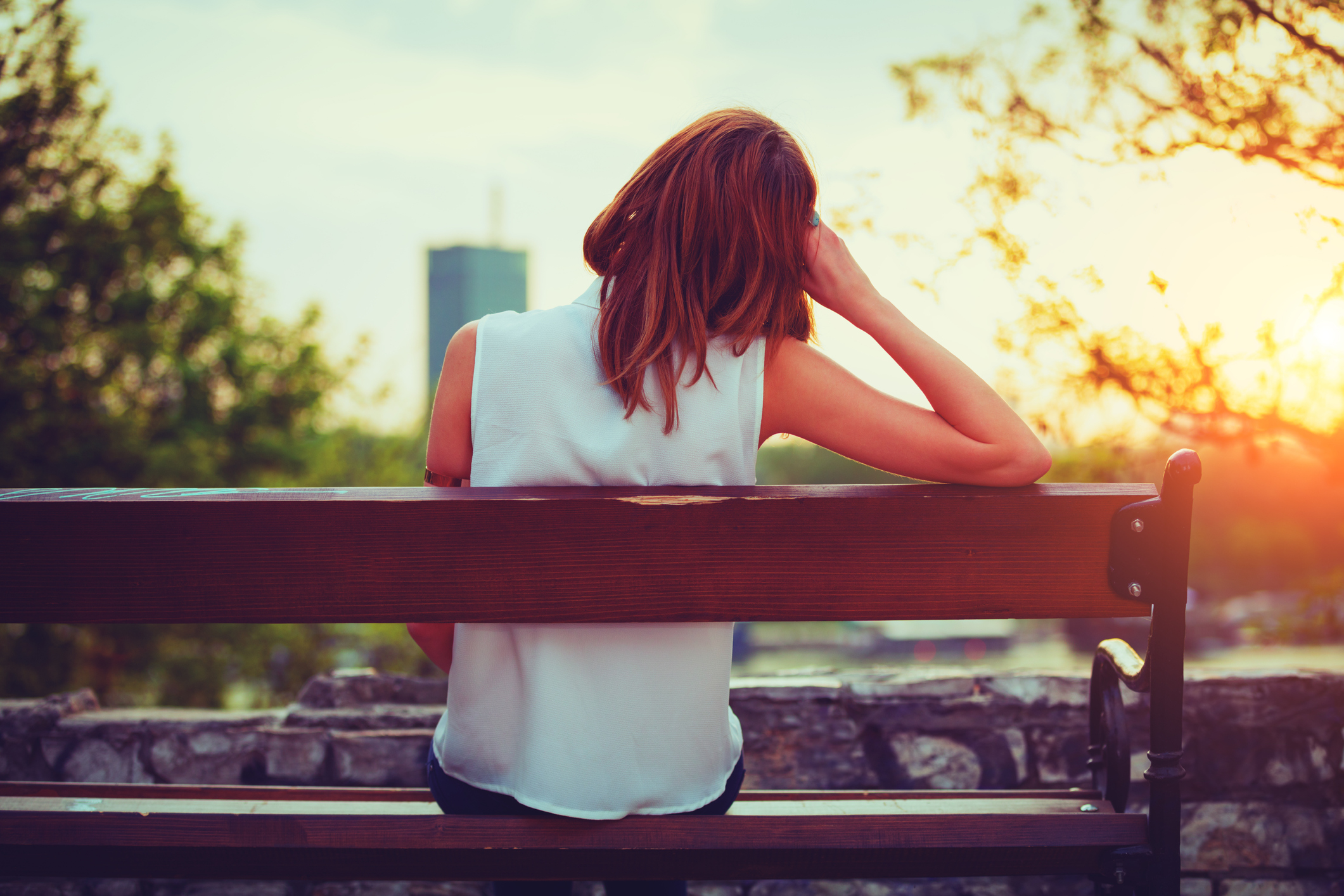 Girl enjoying city view from a bench. Girl enjoying city view from a bench.